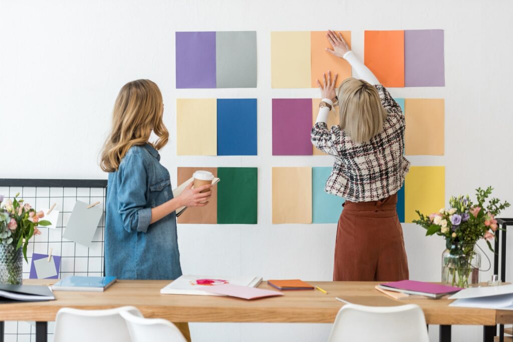 fashionable magazine editors working with color palette in modern office