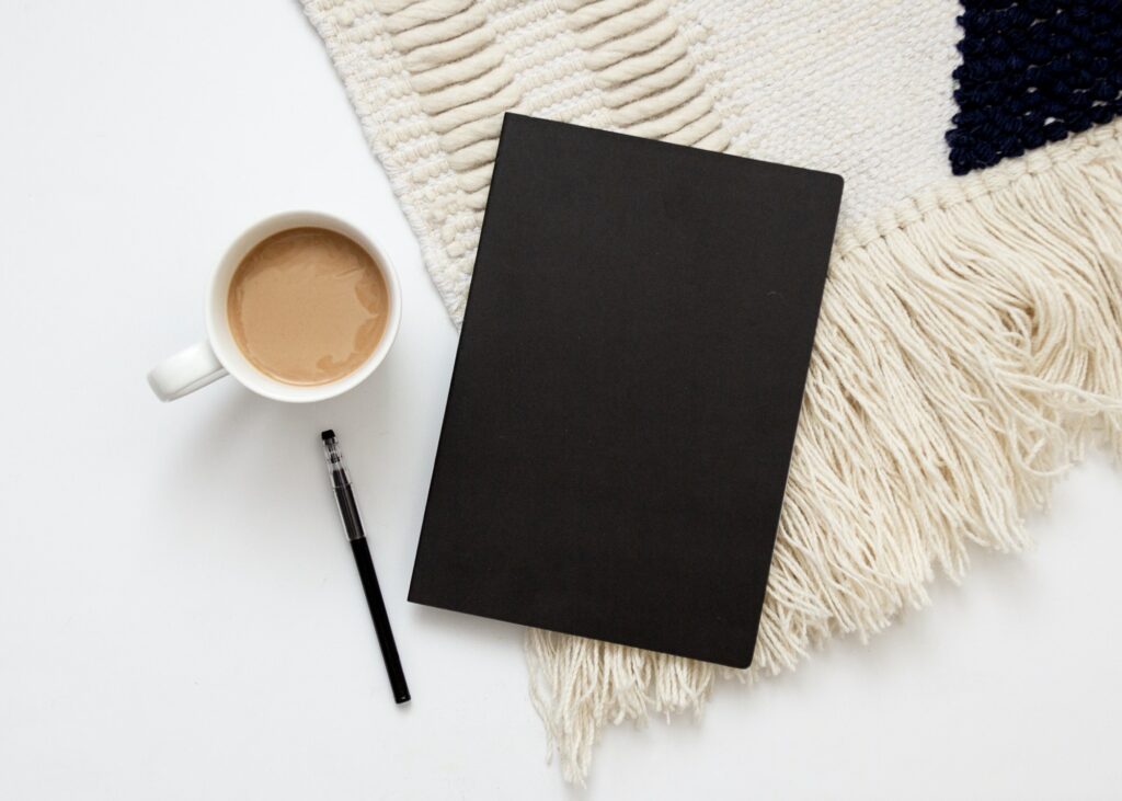 Black notebook with coffee